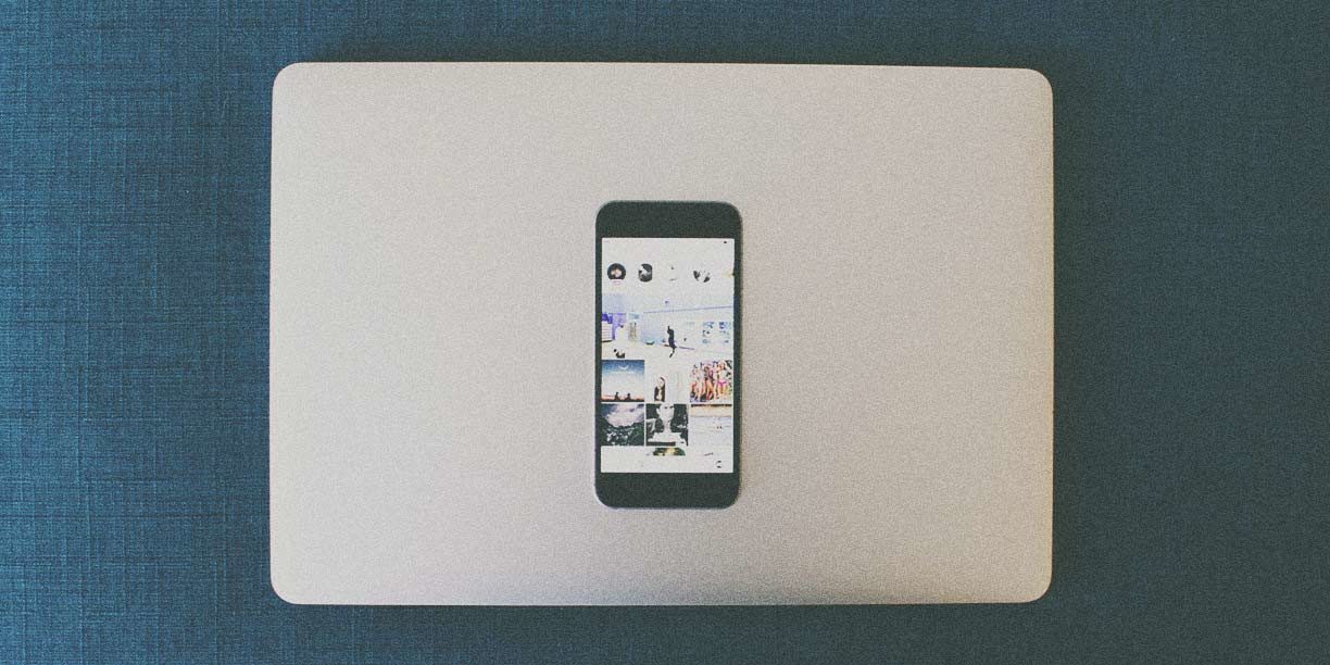 Cell phone resting on top of a closed lap top