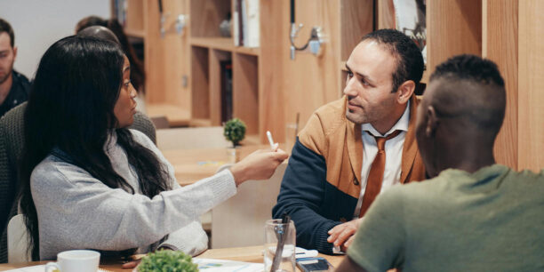 Coworkers discussing their recurring giving program