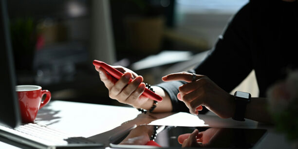 person using a phone to create a social post