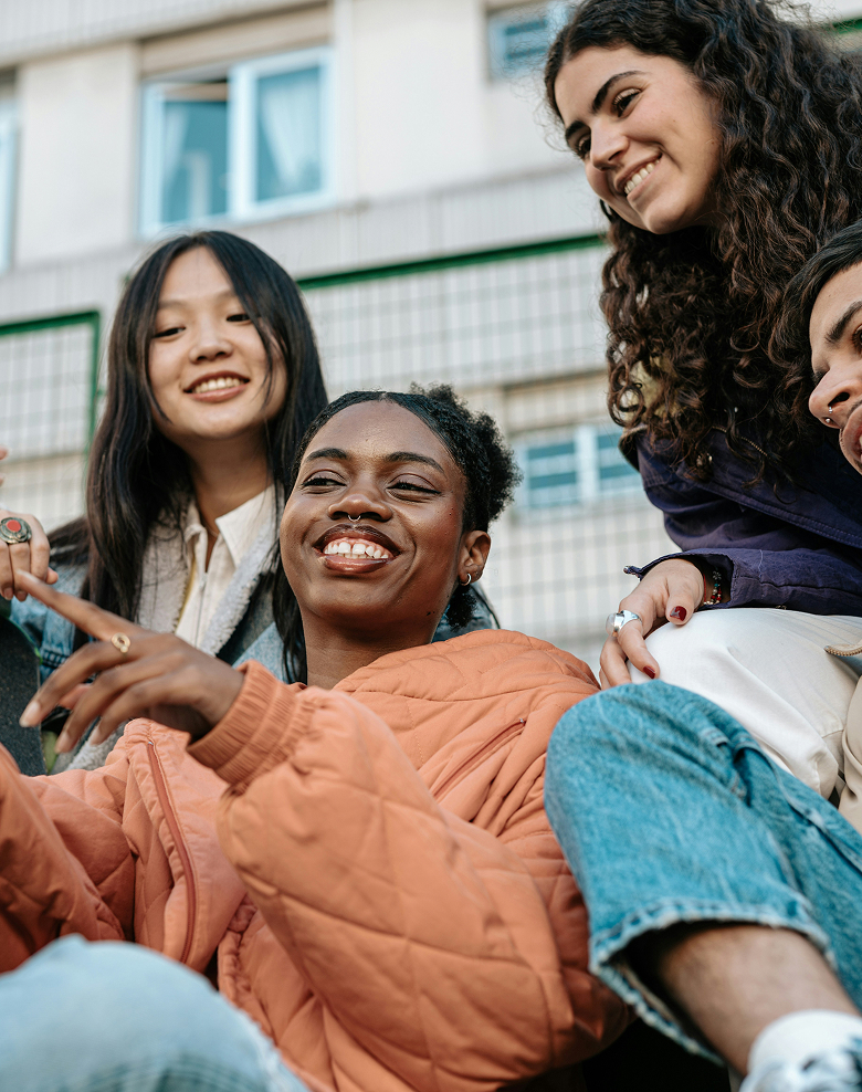 Young people laughing and looking at smartphone together