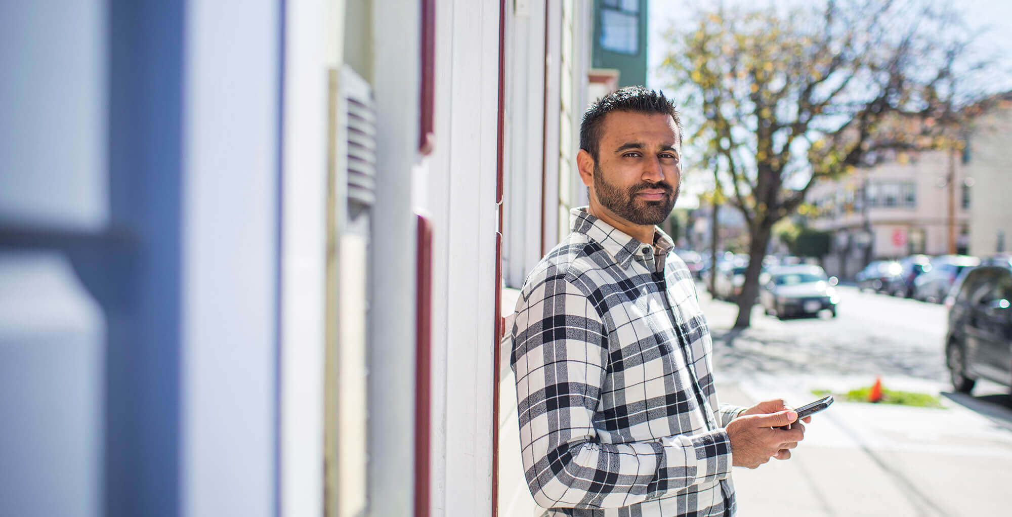 Man standing and holding a cell phone