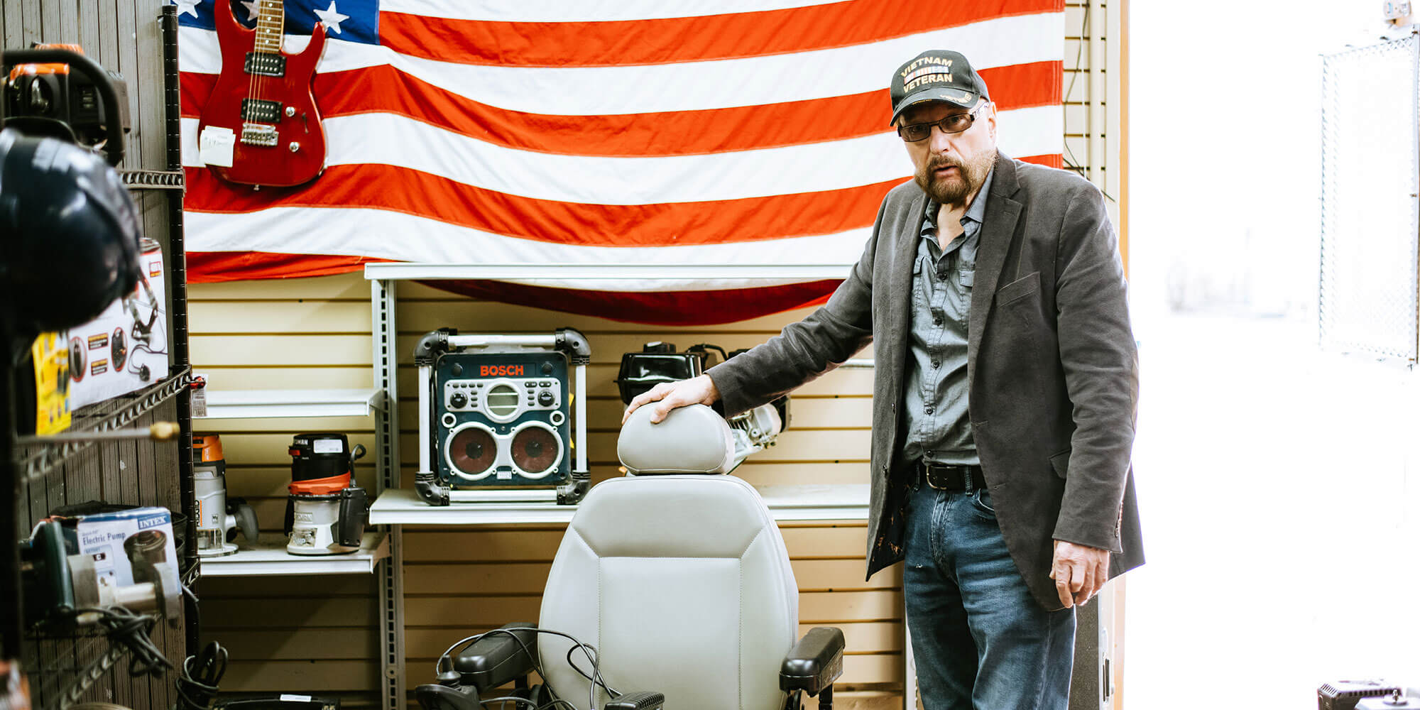 Man standing next to a power chair