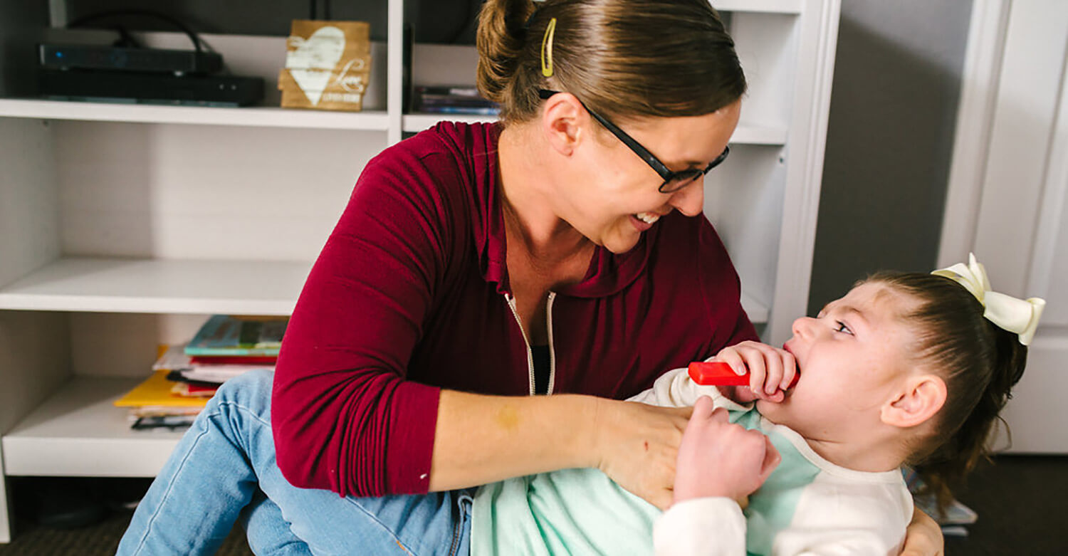 Woman holding a young girl in her arms