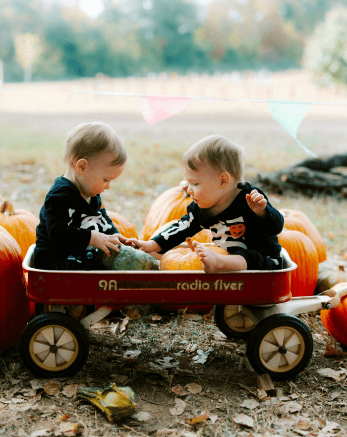 Children in a wagon with pumpkins