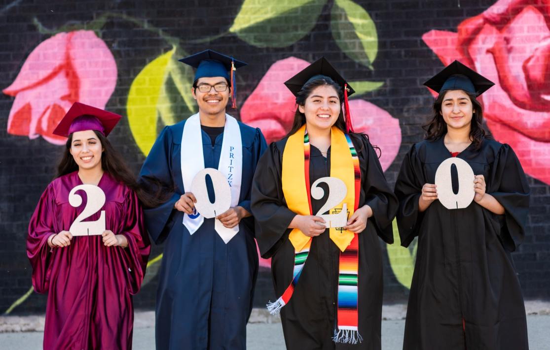 Four students in their cap and gowns