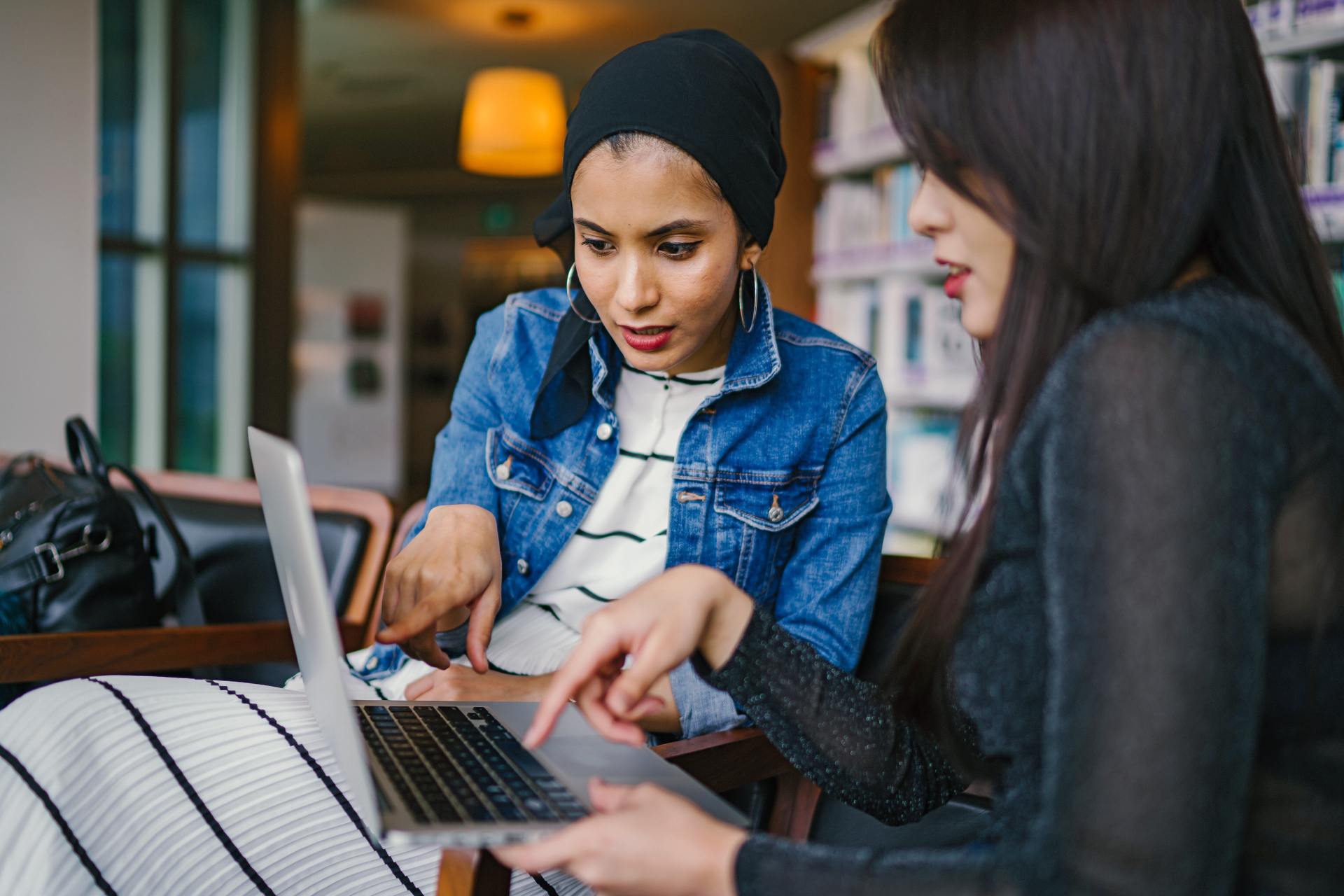 Two people looking at a laptop