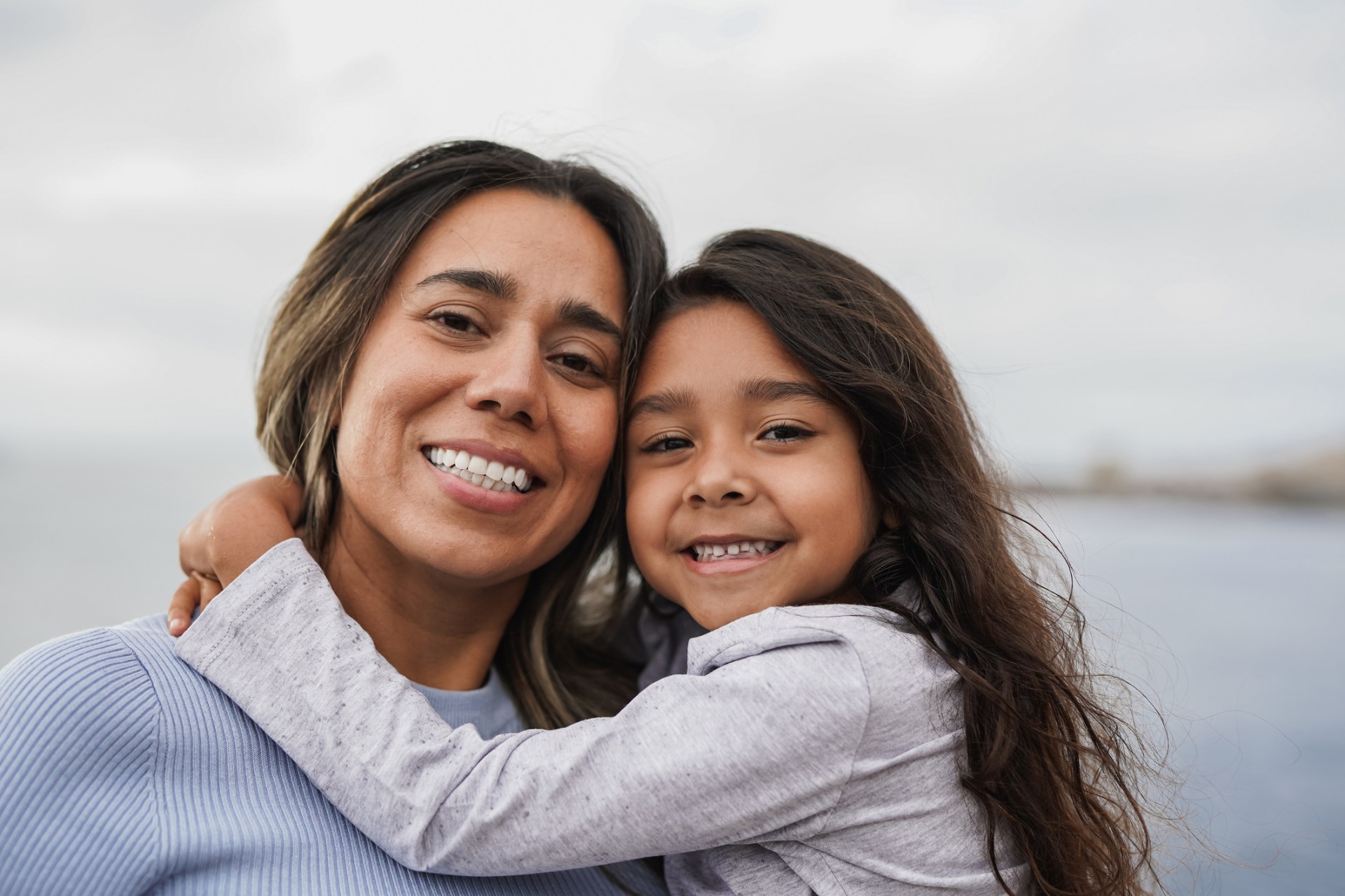 single mom and daughter smiling at camera