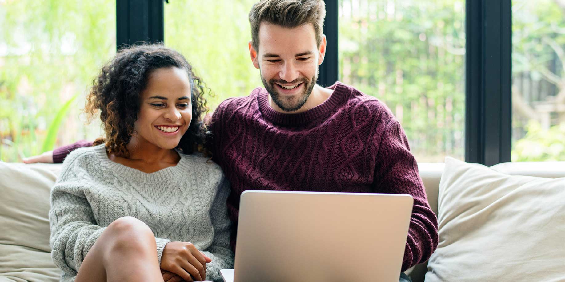 A couple researching donor advised funds on a laptop