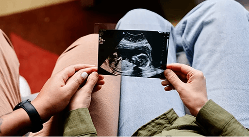 A couple holding an ultrasound