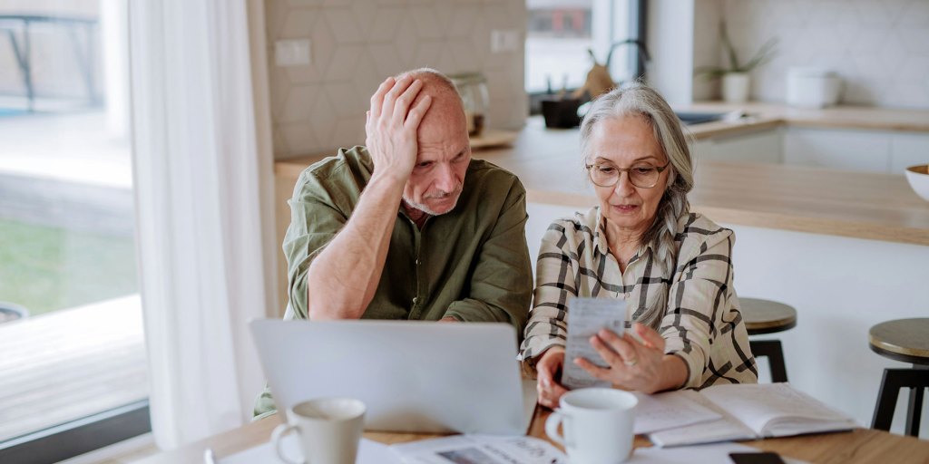 Couple working out debt with a laptop